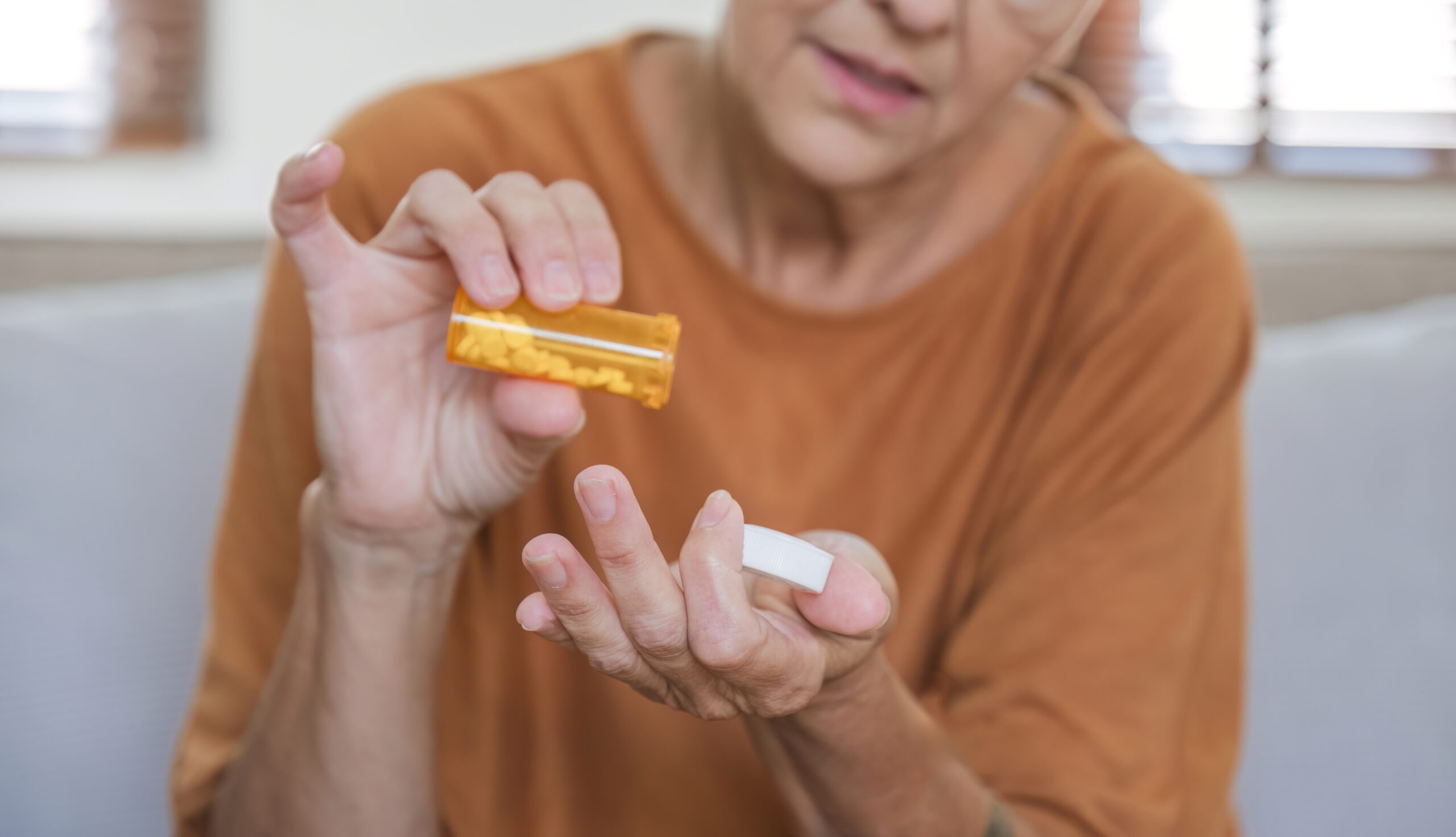 Medicine and hands of a 60 year old woman with health problems Elderly people take health care medicine Painkiller from headache, painkiller, health, medicine, treatment,concept.
